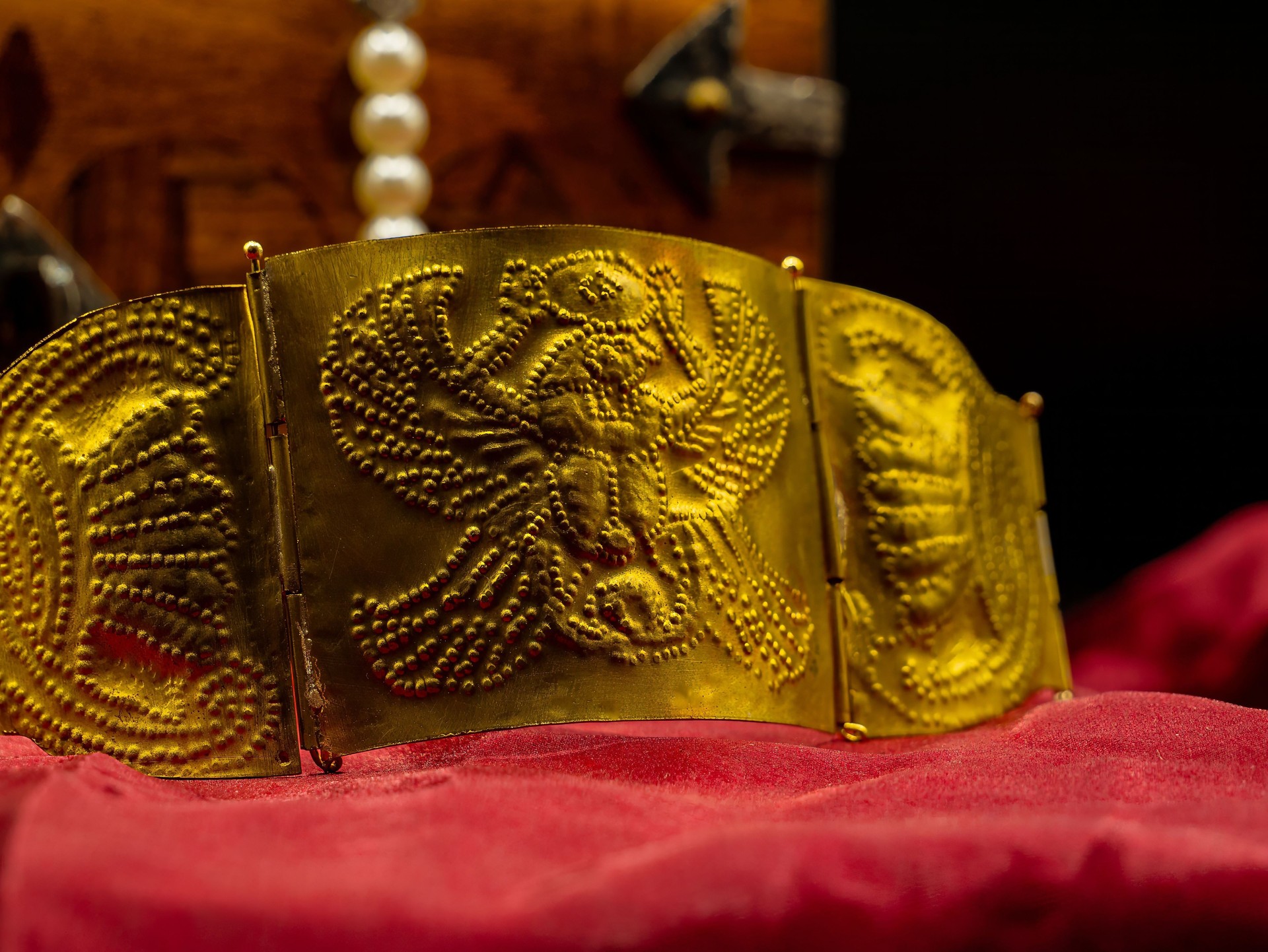 close up shot reproduction of ancient rome golden bracelet with roman eagle decoration